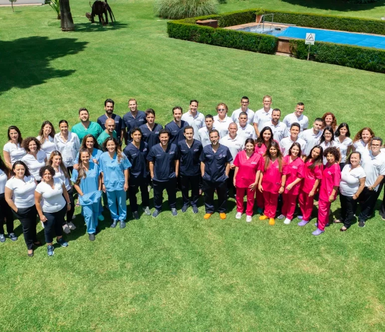 The entire team of Facialteam posing for a group photo, the team counts over 50 facial feminization surgery specialists.