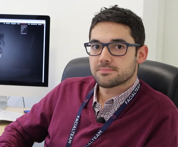 Facial Feminization Scientist dr. Fermín capitán in front of his desk