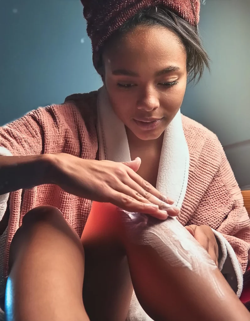 Picture of a trans woman using depilatory cream to shave her legs