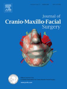 Cover of the Journal of Cranio-Maxillofacial Surgery on a blue background featuring a 3D skull/head model and the journal title.